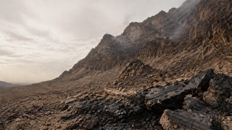 Deuteronomy 4 Commentary - Featured Image - Desolate mountain landscape with rocky foreground