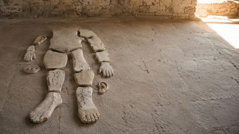 1 Corinthians 12 Commentary - Featured Image - Fragmented body in ancient stone space