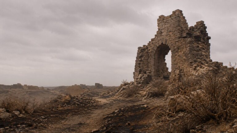 Isaiah 34 Commentary - Featured Image - Desolate ruins under an overcast sky